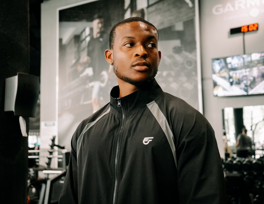 Man in gym wearing athletic jacket